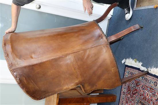 A George III mahogany hide-covered wing chair